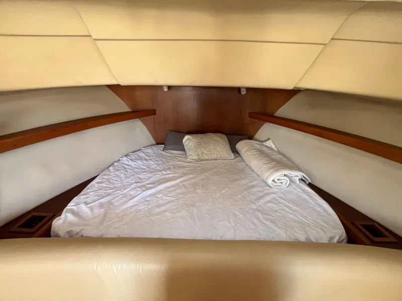 Slide: The Image of Cozy cabin interior of 2005 Mainship RumRunner with neatly made bed. - 32