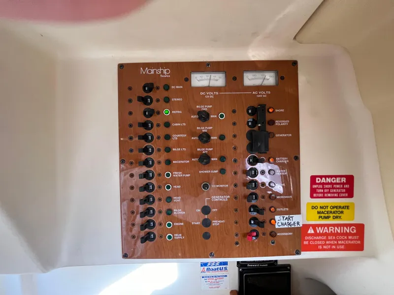 Slide: The Image of Control panel of a 2005 Mainship RumRunner boat with various switches and warning labels. - 36