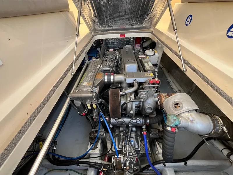 Slide: The Image of 2005 Mainship RumRunner engine compartment, showcasing detailed mechanical components and layout. - 38