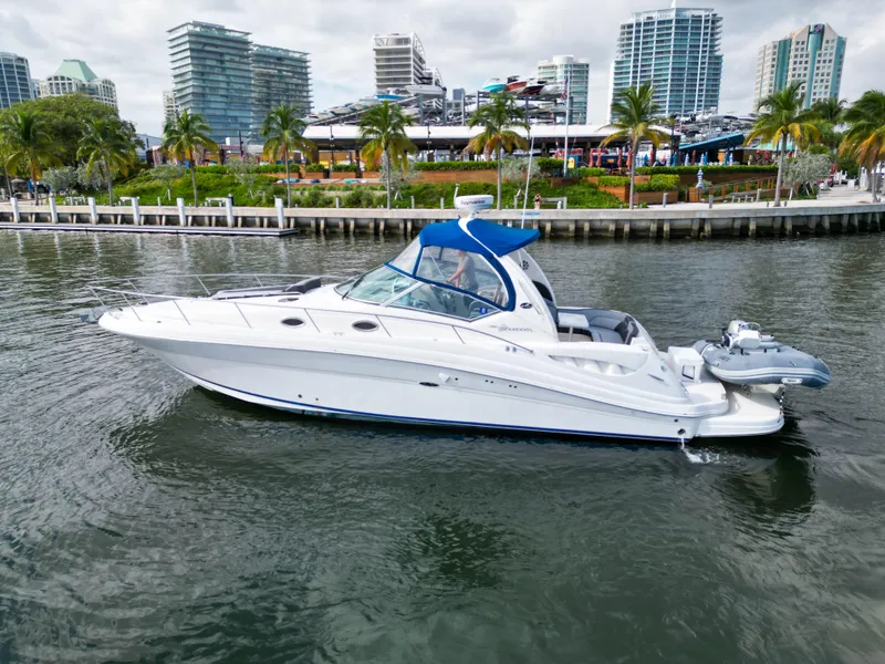 The Image of 2005 Sea Ray 340 Sundancer yacht cruising near urban waterfront. - 0