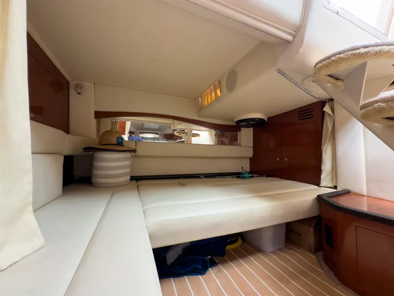 Slide: The Image of Interior cabin of 2005 Sea Ray 340 Sundancer with beige seating and wooden accents. - 10