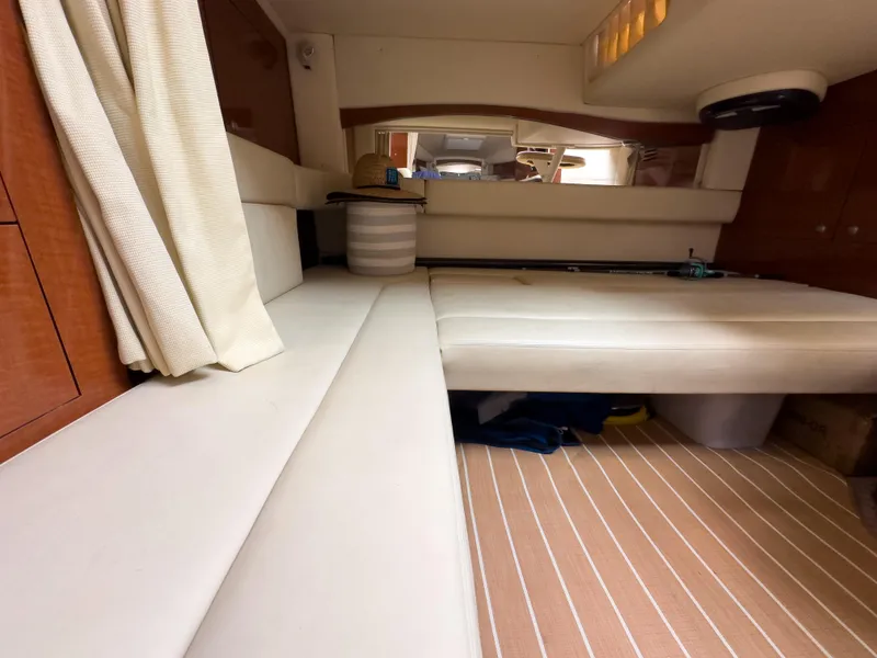 Slide: The Image of Interior cabin of 2005 Sea Ray 340 Sundancer with beige seating and striped flooring. - 11