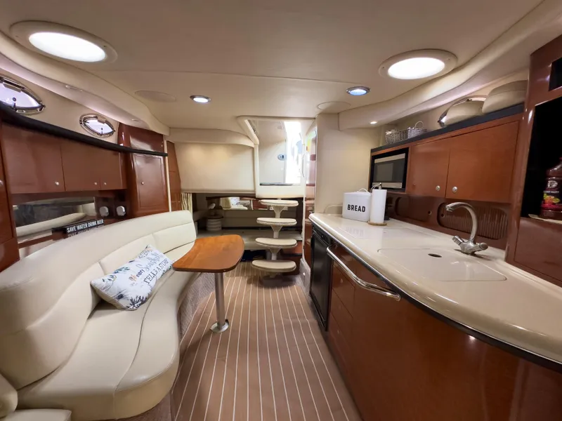 Slide: The Image of Luxurious interior of 2005 Sea Ray 340 Sundancer yacht with modern kitchen and seating area. - 21