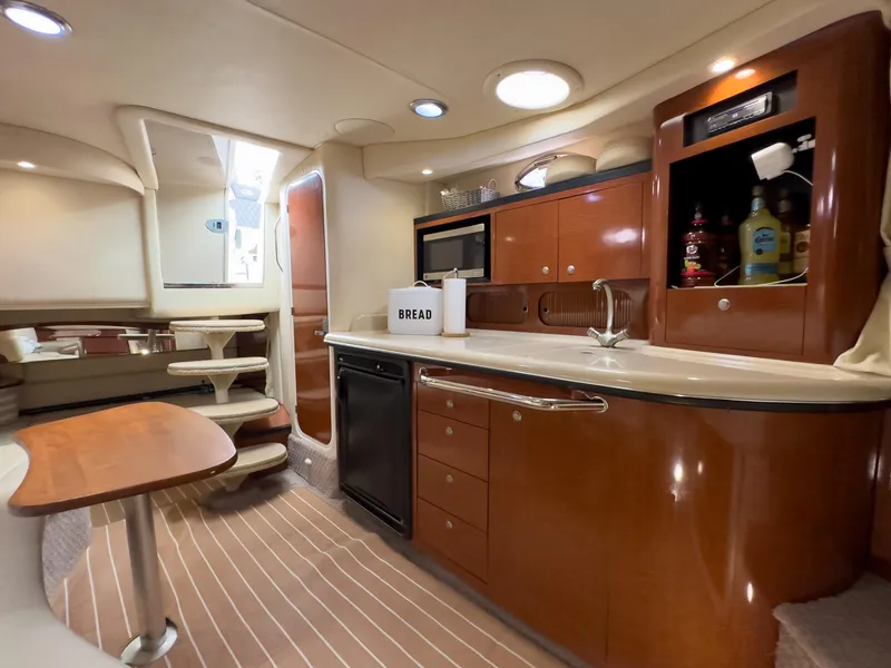 Slide: The Image of Luxurious 2005 Sea Ray 340 Sundancer yacht interior with modern kitchen and dining area. - 23