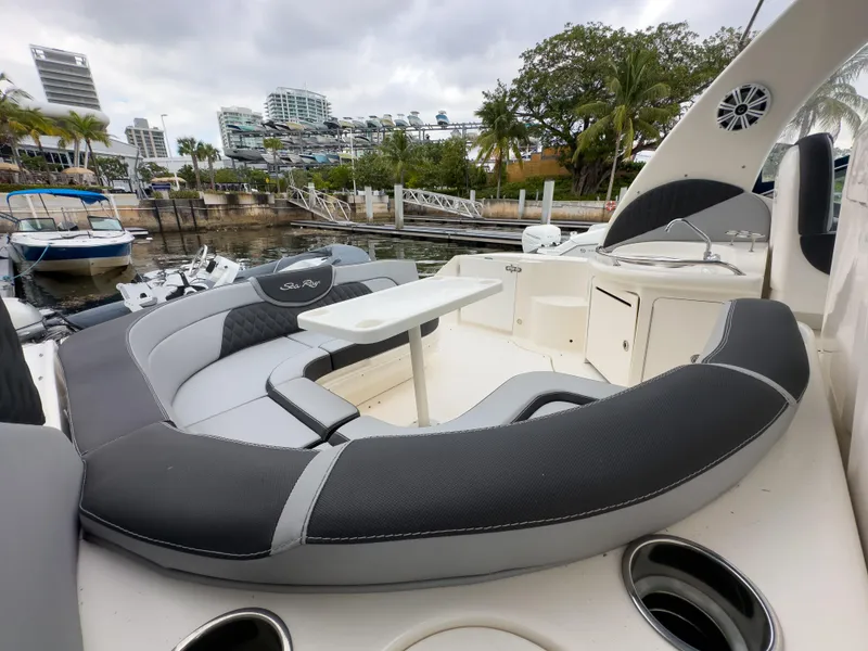 Slide: The Image of 2005 Sea Ray 340 Sundancer boat with spacious seating and table, docked at marina. - 32