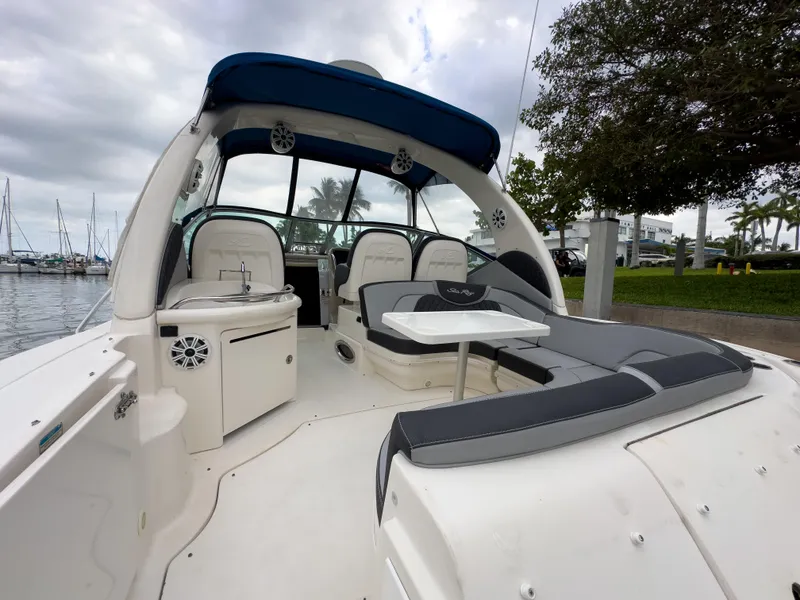 Slide: The Image of 2005 Sea Ray 340 Sundancer boat interior with seating and table, docked at marina. - 34