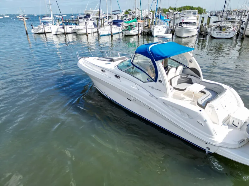 Slide: The Image of 2005 Sea Ray 340 Sundancer boat docked in marina with blue canopy. - 39