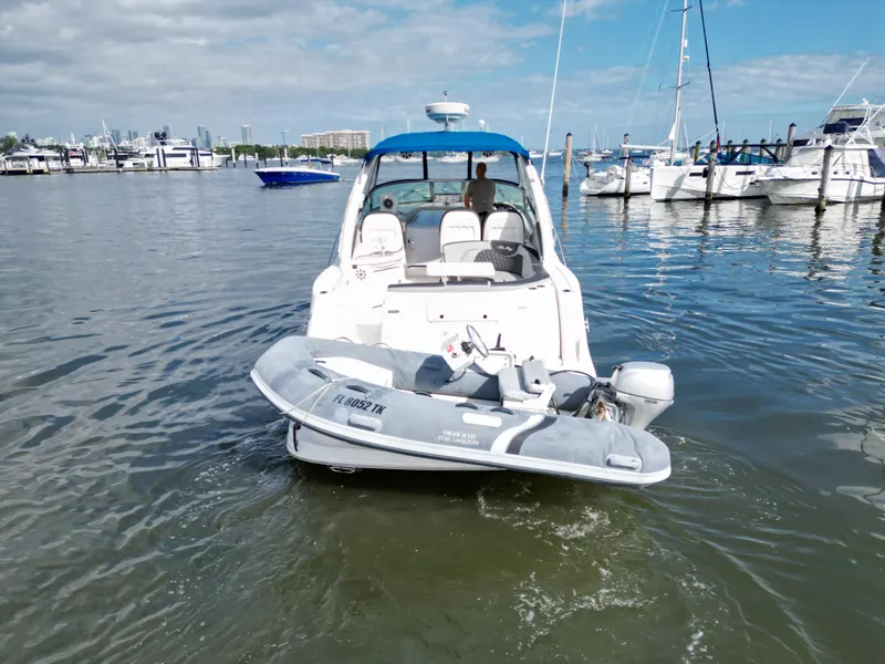 Slide: The Image of 2005 Sea Ray 340 Sundancer yacht docked with inflatable boat in marina. - 41