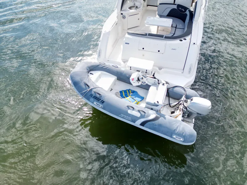 Slide: The Image of 2005 Sea Ray 340 Sundancer with inflatable dinghy on water. - 46