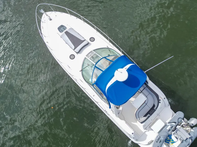 Slide: The Image of Aerial view of 2005 Sea Ray 340 Sundancer boat with blue canopy on water. - 49