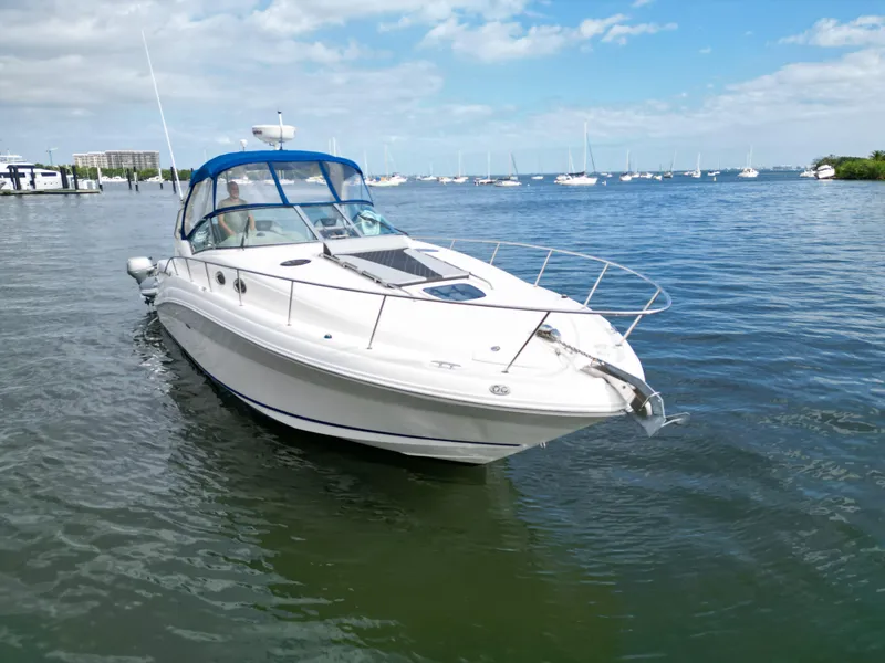 Slide: The Image of 2005 Sea Ray 340 Sundancer yacht on calm water under blue sky. - 5