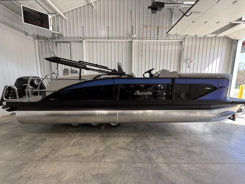 The Image of 2025 Barletta C22M pontoon boat in a garage, showcasing sleek design and modern features. - 1