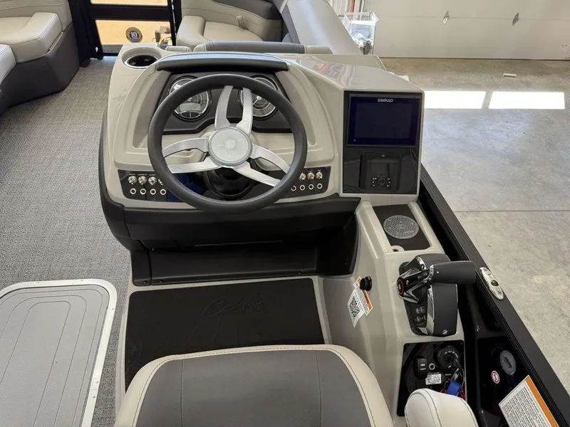 Slide: The Image of 2025 Barletta C22M boat dashboard with steering wheel and control panel. - 16