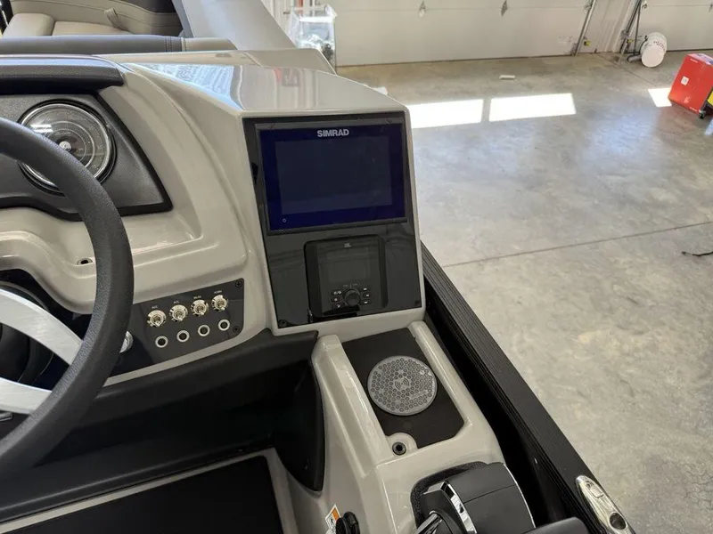 Slide: The Image of 2025 Barletta C22M boat dashboard with Simrad display and controls. - 17