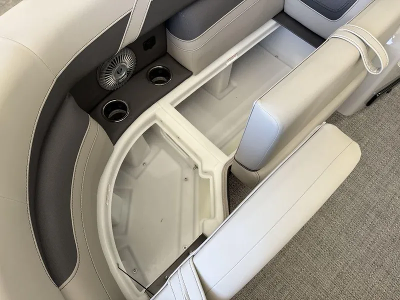 Slide: The Image of 2025 Barletta C22M boat interior with storage compartment and cup holders. - 5