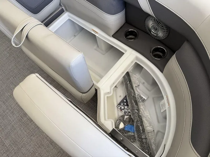 Slide: The Image of 2025 Barletta C22M boat interior storage compartment with cup holders and fan. - 7