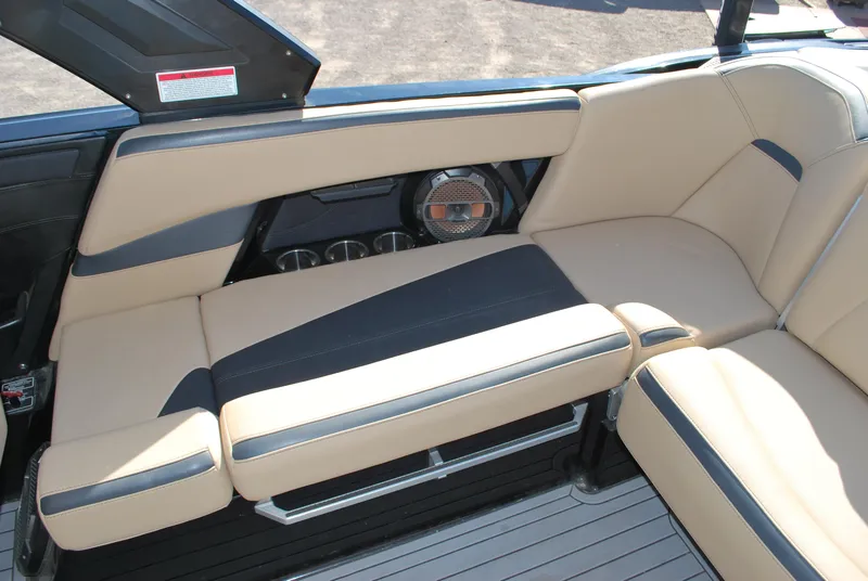 Slide: The Image of 2022 MasterCraft XStar interior with beige and black seating, featuring a built-in speaker. - 13