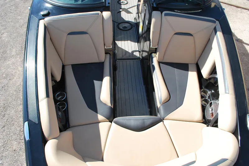 Slide: The Image of 2022 MasterCraft XStar interior with beige and black seating, cup holders, and sleek design. - 5