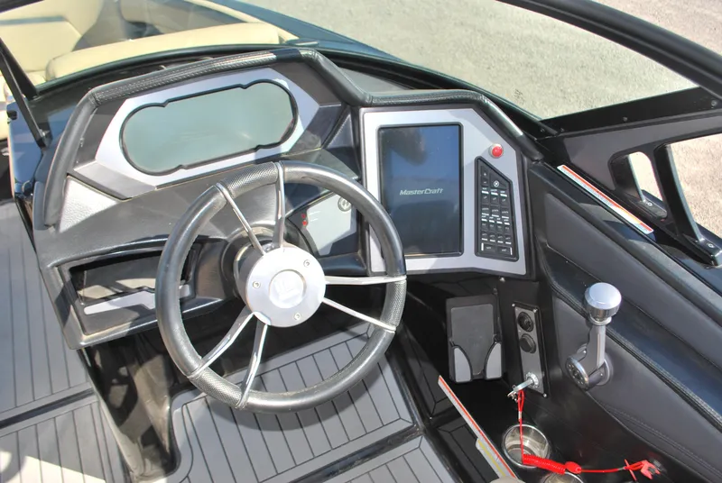 Slide: The Image of 2022 MasterCraft XStar boat dashboard with steering wheel and control panel. - 7