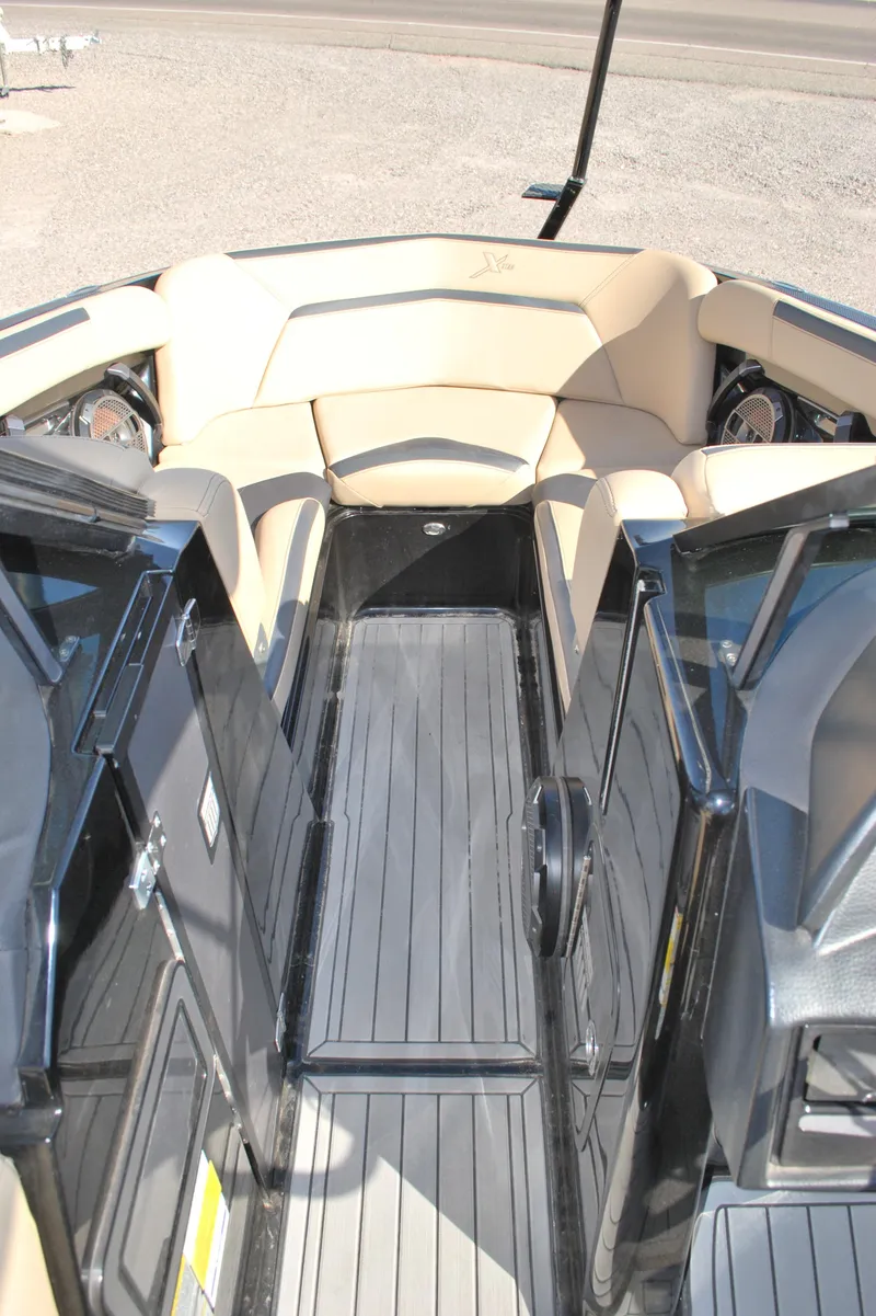 Slide: The Image of 2022 MasterCraft XStar boat interior with sleek seating and modern design. - 9