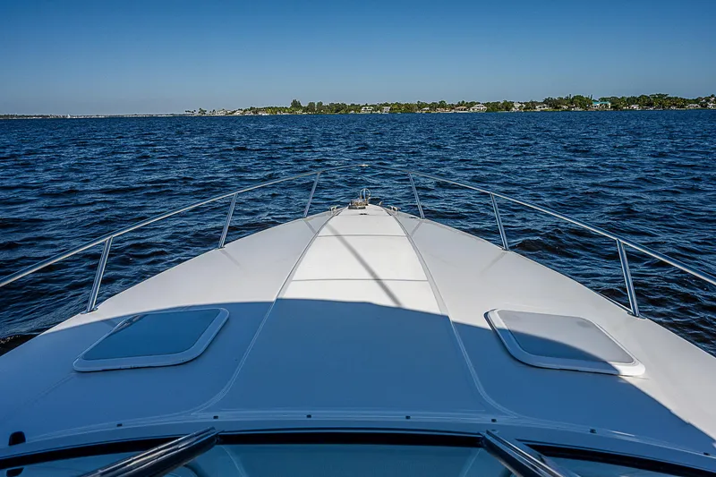 Slide: The Image of 2003 Formula 330 SS Super Sport boat cruising on open water. - 13