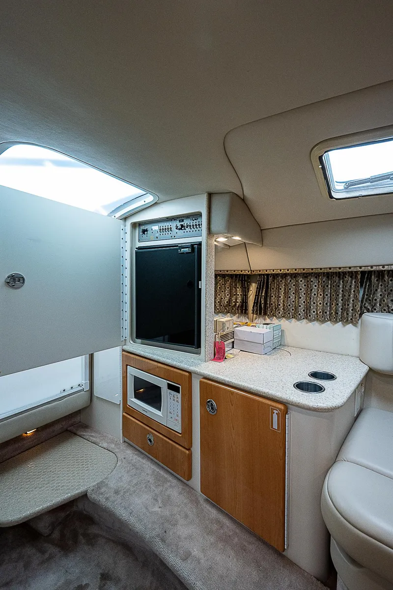 Slide: The Image of Interior of 2003 Formula 330 SS Super Sport boat with kitchenette and seating area. - 18