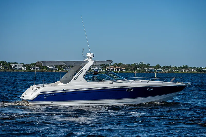 Slide: The Image of 2003 Formula 330 SS Super Sport boat cruising on a sunny day. - 2