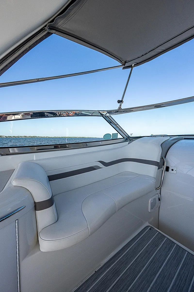Slide: The Image of 2003 Formula 330 SS Super Sport boat interior with cushioned seating and ocean view. - 22
