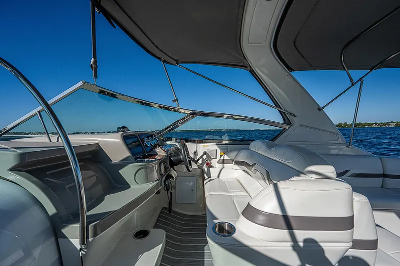 Slide: The Image of Interior of 2003 Formula 330 SS Super Sport boat with sleek seating and dashboard. - 24