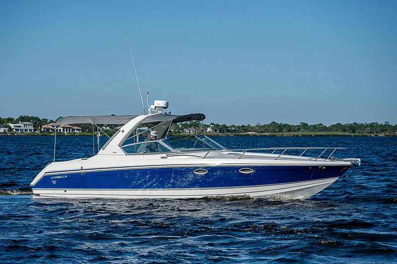 Slide: The Image of 2003 Formula 330 SS Super Sport boat cruising on open water. - 5