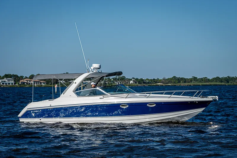 Slide: The Image of 2003 Formula 330 SS Super Sport boat cruising on open water. - 8