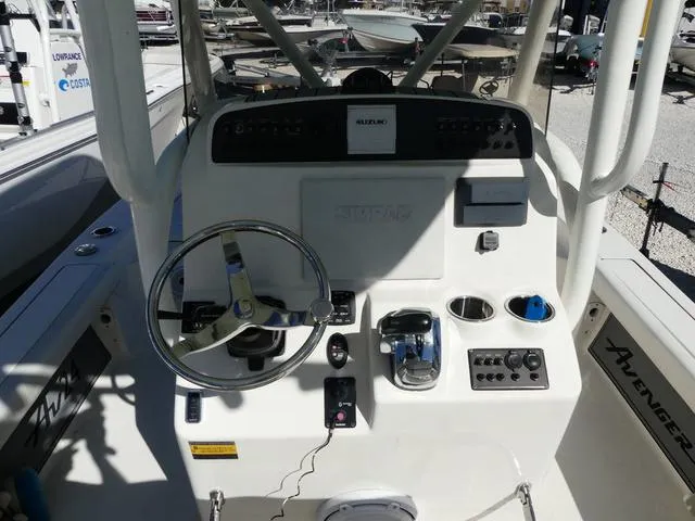 Slide: The Image of 2021 Avenger Boats AV24 helm with steering wheel and control panel. - 11