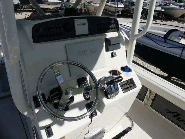 Slide: The Image of 2021 Avenger Boats AV24 console with steering wheel and controls. - 12