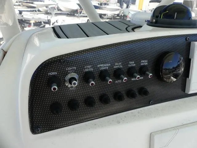 Slide: The Image of Control panel of a 2021 Avenger Boats AV24 with various switches and dials. - 13