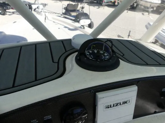 Slide: The Image of 2021 Avenger Boats AV24 dashboard with Suzuki controls and compass. - 15