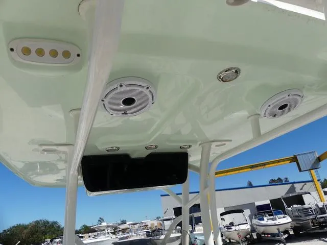 Slide: The Image of 2021 Avenger Boats AV24 T-top with speakers and lights, docked at marina. - 19