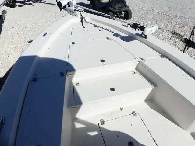 Slide: The Image of 2021 Avenger Boats AV24 deck with storage compartments and trolling motor. - 24