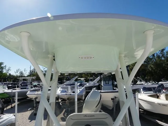 Slide: The Image of 2021 Avenger Boats AV24 with T-top, docked among other boats under clear blue sky. - 27