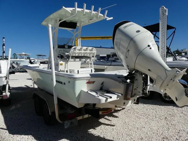 Slide: The Image of 2021 Avenger Boats AV24 with outboard motor on trailer in sunny marina. - 6