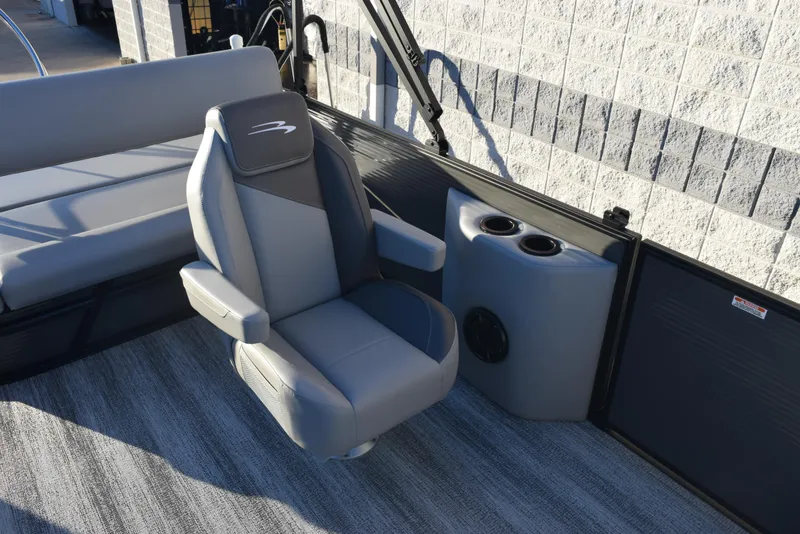 Slide: The Image of 2025 Bennington 23 SSBSE boat interior with gray captain's chair and cup holders. - 10