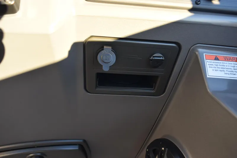 Slide: The Image of Dashboard of 2025 Bennington 23 SSBSE boat with power outlet and warning label. - 17