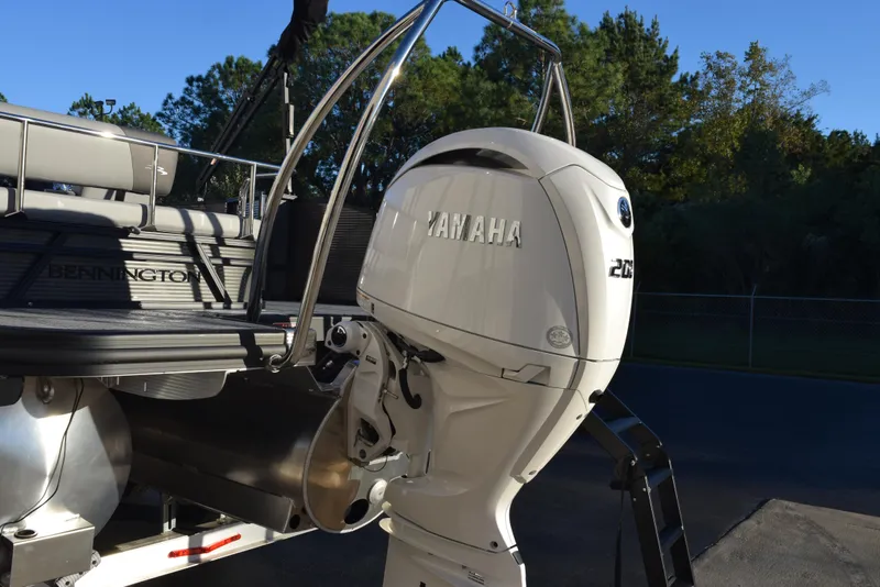 Slide: The Image of 2025 Bennington 23 SSBSE boat with Yamaha 250 outboard motor, parked outdoors. - 5