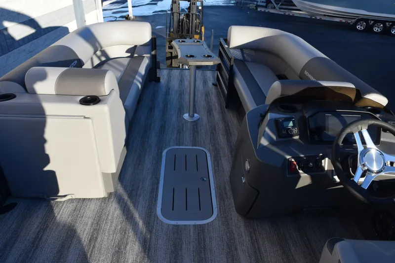 Slide: The Image of 2025 Bennington 23 SSBSE pontoon boat interior with plush seating and modern dashboard. - 7
