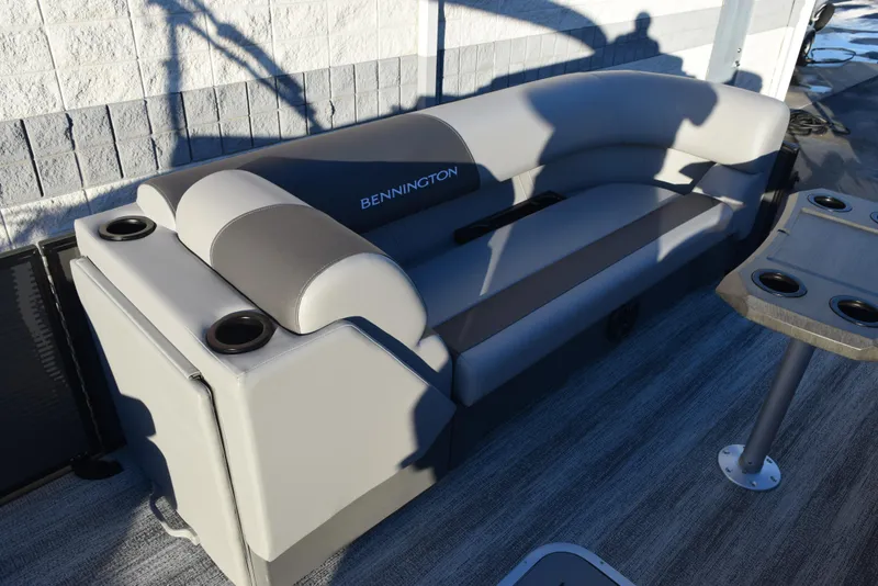 Slide: The Image of 2025 Bennington 23 SSBSE boat interior with gray seating and cup holders. - 9