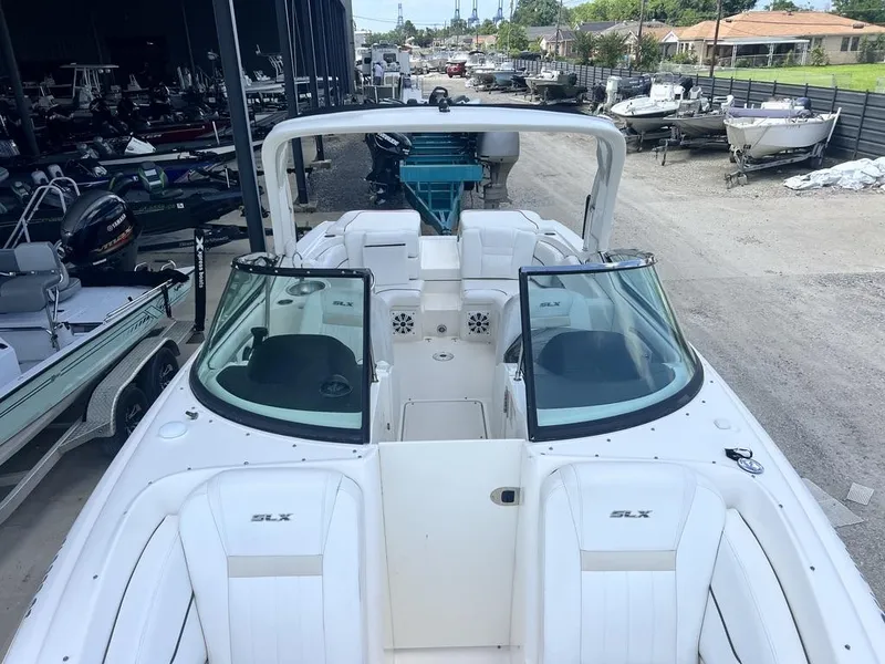 Slide: The Image of 2008 Sea Ray 270 SLX boat in a marina, showcasing sleek design and spacious seating. - 10