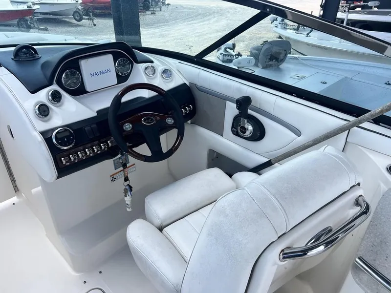 Slide: The Image of 2008 Sea Ray 270 SLX boat cockpit with steering wheel and navigation system. - 11