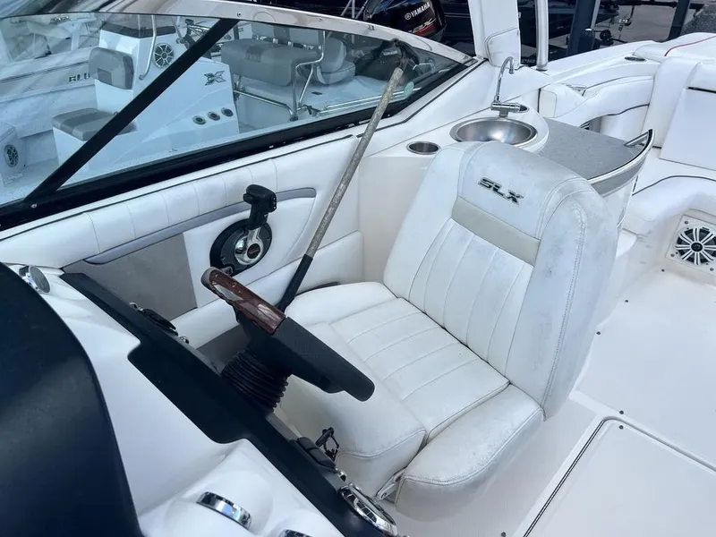Slide: The Image of 2008 Sea Ray 270 SLX boat interior with white seating and steering wheel. - 12