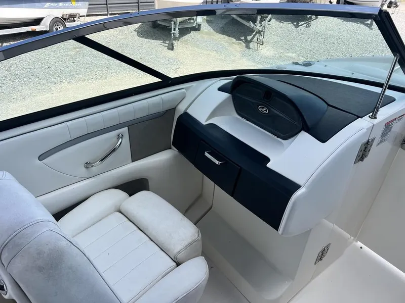 Slide: The Image of 2008 Sea Ray 270 SLX boat interior with white seating and dashboard. - 13
