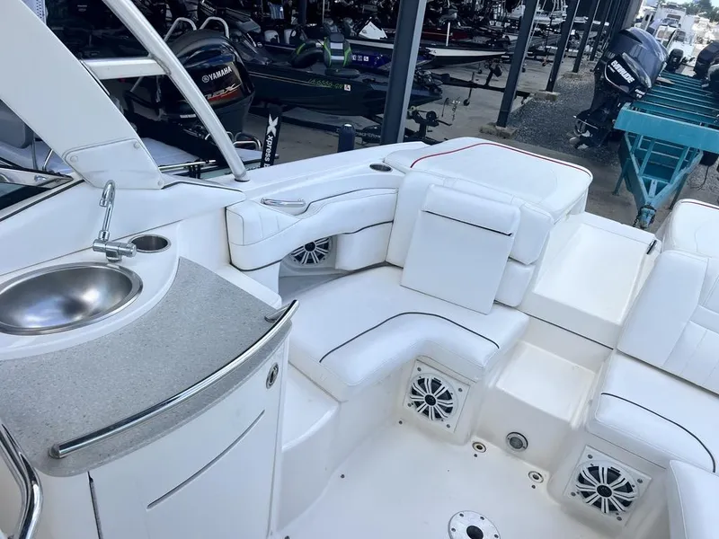 Slide: The Image of 2008 Sea Ray 270 SLX boat interior with white seating and built-in sink. - 15