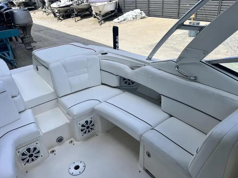 Slide: The Image of 2008 Sea Ray 270 SLX boat with white leather seating and built-in speakers. - 16
